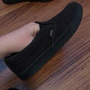 Black pair of slip on vans
